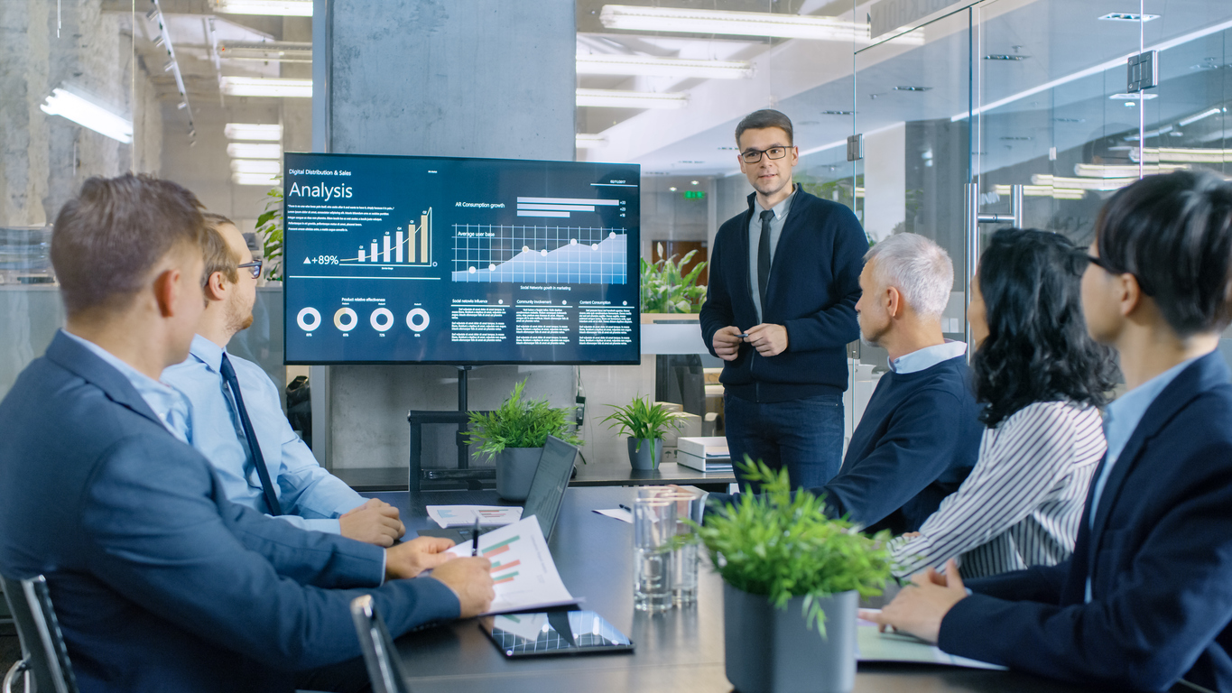 Young Stock Trader Shows To The Executive Managers Cryptocurrency And Trade Market Correlation Pointing At The Wall Tv. Young Stock Trader Shows To The Executive Managers Cryptocurrency And Trade Market Correlation Pointing At The Wall Tv.